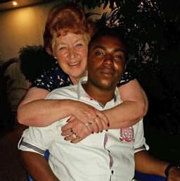 CJ Nwachukwu held from back by Angela.