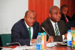Central Bank of Nigeria (CBN) Governor, Mr. Godwin Emefiele (left) addressing the House of Reps C'ttee on Banking & Currency at a meeting between the Bank and the C'ttee held at the House of Reps New Building, Abuja, on July 16, 2014. Right is CBN Deputy Governor (Financial System Stability), Dr. Kingsley Moghalu.