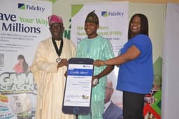 L-R: President, Lagos Chamber of Commerce and Industry (LCCI), Babatunde Ruwase; N500,000.00 Beneficiary of Fidelity Savings Loyalty Scheme (FSLS), Abubakar Azeez Ishola; Executive Director, Shared Services and Products, Fidelity Bank Plc, Chijioke Ugochukwu; during the cheque presentation to Fidelity Savings Loyalty Scheme at the Lagos International Trade Fair in Tafawa Balewa Square, Lagos. 
