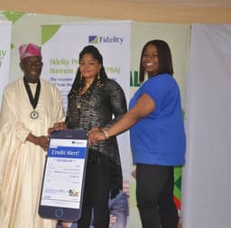 L-R: President, Lagos Chamber of Commerce and Industry (LCCI), Babatunde Ruwase; N500,000.00 Beneficiary of Fidelity Savings Loyalty Scheme (FSLS), Maryann Obiageli Ezedinachi; Executive Director, Shared Services and Products, Fidelity Bank, Chijioke Ugochukwu; during the cheque presentation to beneficiaries of Fidelity Savings Loyalty Scheme at the Lagos International Trade Fair in Tafawa Balewa Square, Lagos.  