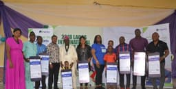 President, Lagos Chamber of Commerce and Industry (LCCI), Babatunde Ruwase (5th left); Executive Director, Shared Services and Products, Fidelity Bank, Chijioke Ugochukwu (5th right) flanked by beneficiaries of Fidelity Savings Loyalty Scheme (FSLS), during the cheque presentation to beneficiaries of Fidelity Savings Loyalty Scheme at the Lagos International Trade Fair in Tafawa Balewa Square, Lagos. 