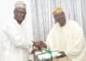 Kwara State Governor, Dr Abdulfatah Ahmed (left) presenting sourvenir to the representative of the President, Omupo Descendant Union, Prof Raphael Dele Olarinoye during courtesy visit to the Governor at Government House, Ilorin, on Tuesday, July 24, 2018.

