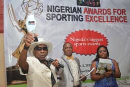 Photo shows Prince Oduah displaying an award which was presented to chief Agbamu at the Nigerian Award For Sporting Excellence organised by Daily Sports Nigeria, held on Saturday night, December 2, at Airport Hotel, Ikeja, Lagos.
