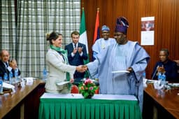 President Mohammadu Buhari and the President of France, Mr. Emmanuel Macron, watch, as the Ogun State Governor, Senator Ibikunle Amosun and Rachel  Kolbe, General Manager of France based In-Vivo Foundation, shake hands, after signing a Letter of Intent on the kick off of the "Ile Dotun" project implementation at State House, Abuja . . . on Tuesday, July 4, 2018.