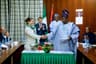 President Mohammadu Buhari and the President of France, Mr. Emmanuel Macron, watch, as the Ogun State Governor, Senator Ibikunle Amosun and Rachel  Kolbe, General Manager of France based In-Vivo Foundation, shake hands, after signing a Letter of Intent on the kick off of the "Ile Dotun" project implementation at State House, Abuja . . . on Tuesday, July 4, 2018.