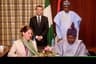 President Mohammadu Buhari and the President of France, Mr. Emmanuel Macron, watch, as the Ogun State Governor, Senator Ibikunle Amosun and Rachel  Kolbe, General Manager of France based In-Vivo Foundation, sign a Letter of Intent on the kick off of the "Ile Dotun" project implementation at State House, Abuja . . . on Tuesday, July 4, 2018 