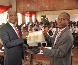  L-R : Executive Director, Lagos and West Bank, Marketing, United Bank for Africa, Liadi Ayoku donating books and other gift items  to the Vice Principal, Academic, Olivet Baptist High School, Oyo, Oyo State, Mr. E.A Adedeji, during the financial literacy training programme for students of the school, an  initiative of Central Bank of Nigeria, in commemoration of World Savings Day on Monday 31st October, 2016. In Oyo, Oyo State.
