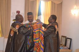 GHANAIANS HONOUR AKPABIO: Governor Godswill Akpabio of Akwa Ibom State being decorated with the traditional attire of Ghana by Mr. Kofi Nyaik (left), Director of the Millennium Excellence Foundation, Ghana, after receiving the Lifetime Africa Achievement Prize Award today at the Government House, Uyo. The President of the Foundation, Ambassador Ashim Morton (right), looks on.