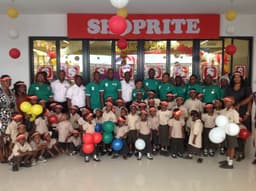 L-R: Peter Oladipo, Sales Manager; Kazeem Olasunkanmi, Admin Manager; and the
Branch Manager, Fatai Oshungboye, surrounded by staff and children of Godâ€™s Heritage Private School during the opening of Shopriteâ€™s 10th and biggest store in Ibadan on June 19, 2014.
