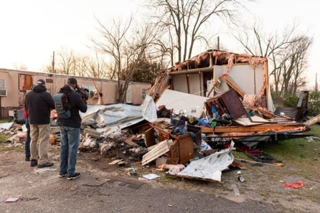 At least 20 dead as storms sweep across US