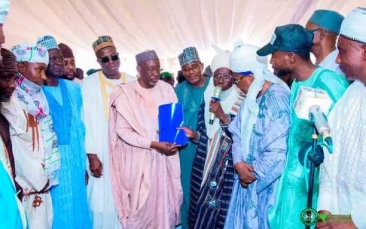 Governor tears defectors? PDP membership cards, opposition party demands apology