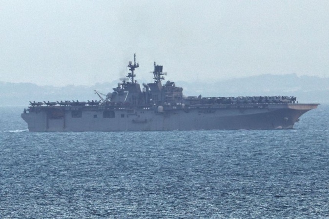 US warship believed to be carrying Marine ground troops to Middle East tracked off Singapore