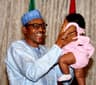 President Muhammadu Buhari beams with smiles as he plays with grand-daughter after immunising her . . . late July in Abuja. Photo: State House.