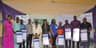 President, Lagos Chamber of Commerce and Industry (LCCI), Babatunde Ruwase (5th left); Executive Director, Shared Services and Products, Fidelity Bank, Chijioke Ugochukwu (5th right) flanked by beneficiaries of Fidelity Savings Loyalty Scheme (FSLS), during the cheque presentation to beneficiaries of Fidelity Savings Loyalty Scheme at the Lagos International Trade Fair in Tafawa Balewa Square, Lagos.